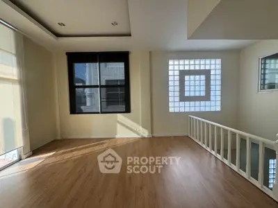 Spacious and bright living room with modern design and large windows.