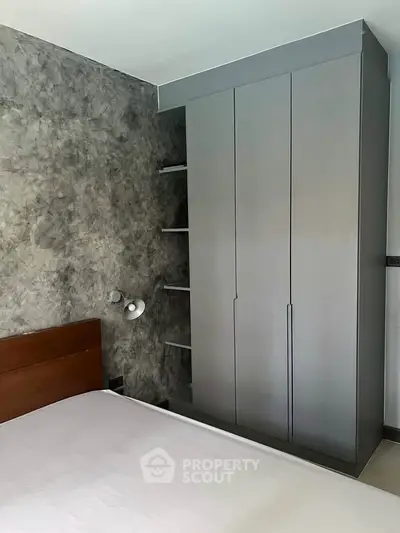 Modern bedroom with sleek wardrobe and textured wall design