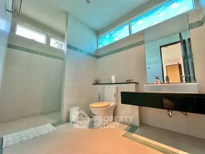 Spacious modern bathroom with sleek fixtures and natural light