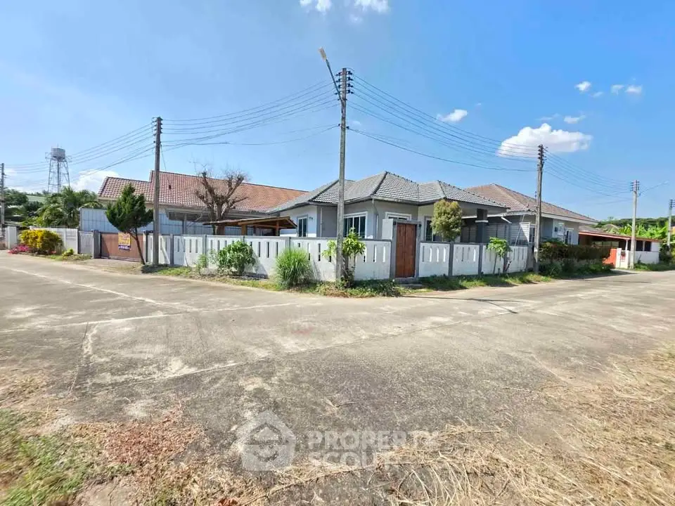 Charming suburban homes with fenced yards and clear blue skies.