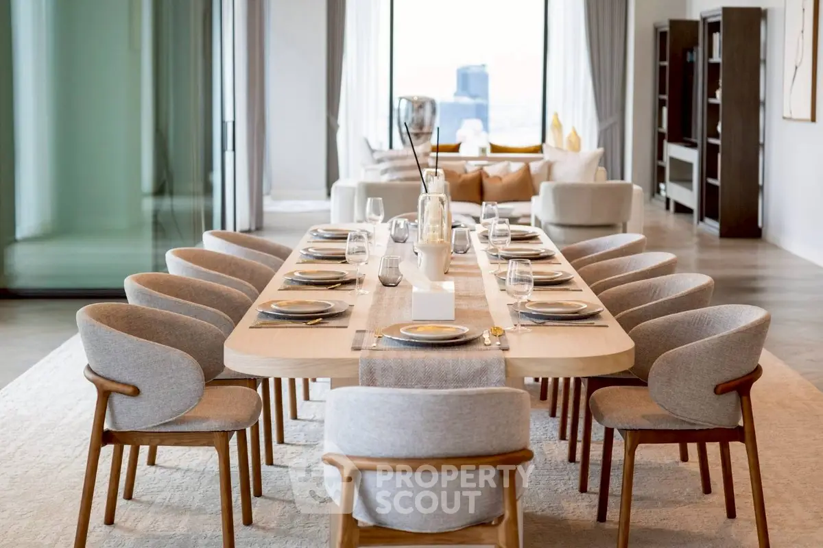 Luxurious open-plan dining and living area with elegant furnishings and city view.