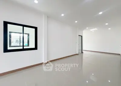 Spacious modern interior with sleek tiled flooring and ample natural light, perfect for customization.