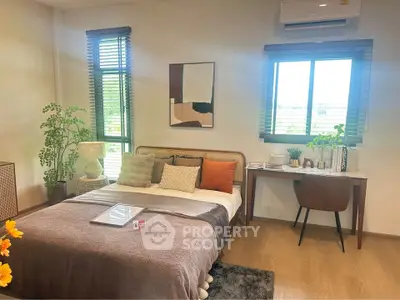 Modern bedroom with stylish decor, large windows, and cozy ambiance