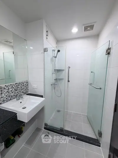 Modern bathroom with glass shower enclosure and sleek design