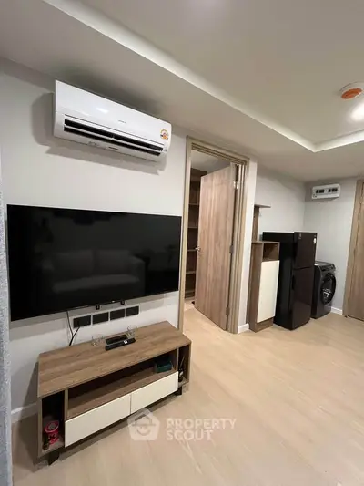 Modern living room with air conditioning and sleek wooden furniture