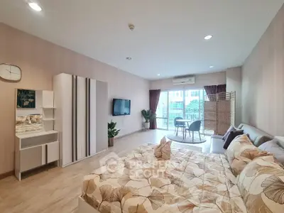 Spacious modern bedroom with stylish decor and balcony access