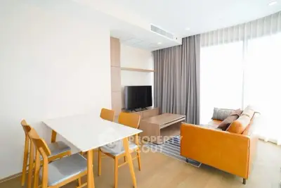 Modern living room with stylish furniture and natural light, perfect for relaxation and entertainment.