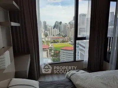 Stunning bedroom with panoramic city view in a high-rise apartment, offering a serene urban living experience.