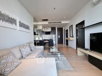 Modern living room with open kitchen, sleek furniture, and stylish decor