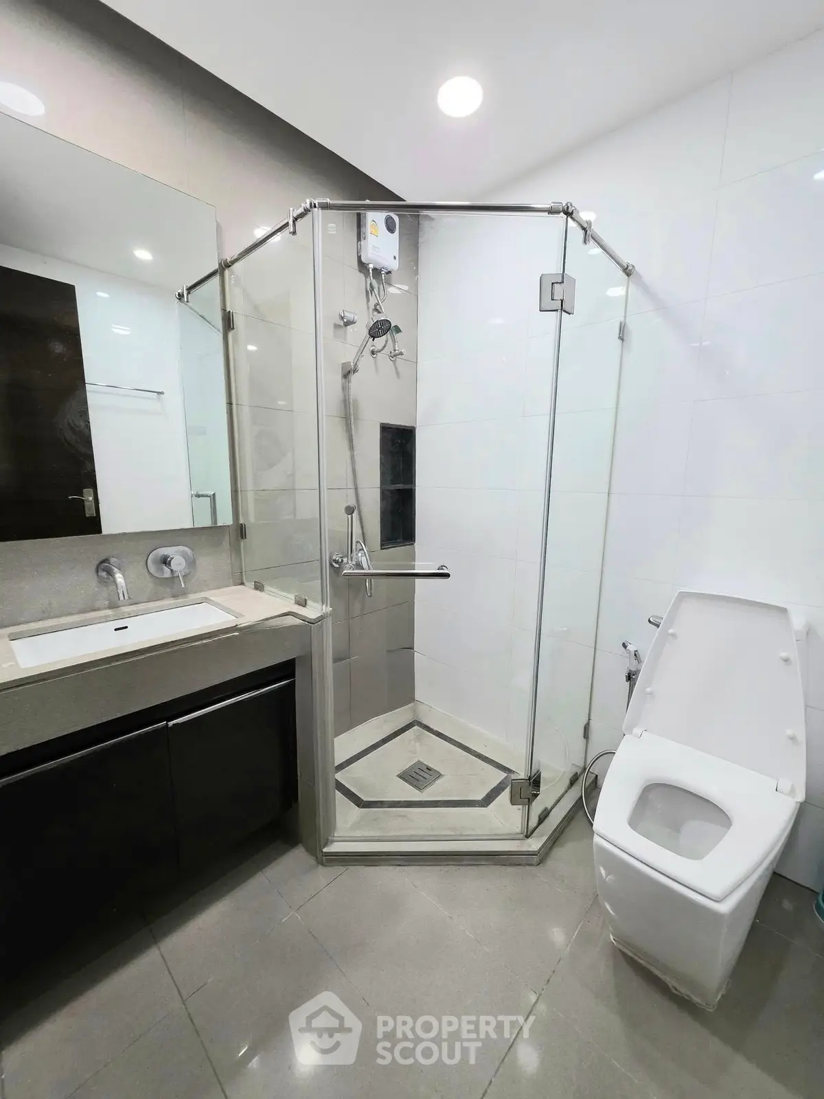 Modern bathroom with glass shower enclosure and sleek fixtures