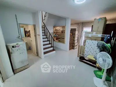 Spacious interior with staircase and storage boxes, ideal for organizing and customization.