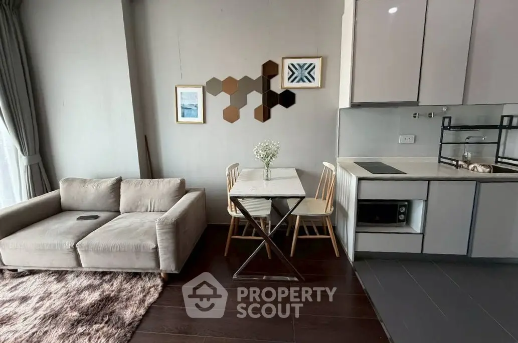 Modern living room with cozy sofa, stylish decor, and compact dining area in open-plan layout.