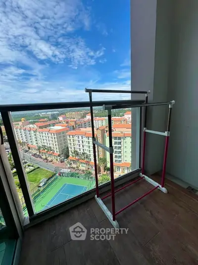Stunning balcony view with cityscape and tennis court, perfect for urban living.