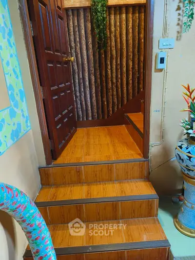 Charming wooden staircase leading to a cozy interior with rustic decor