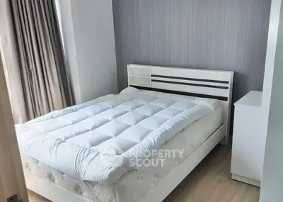 Cozy bedroom with modern white bed and elegant gray accent wall