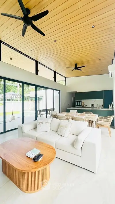 Spacious modern living room with high ceilings and open kitchen layout