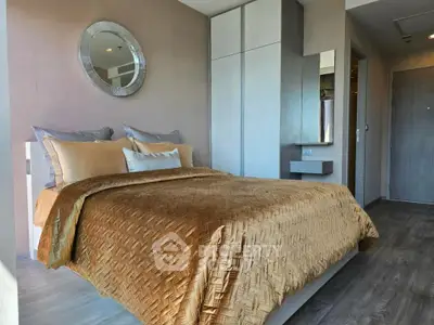 Modern bedroom with stylish decor and cozy bedding in a contemporary apartment.
