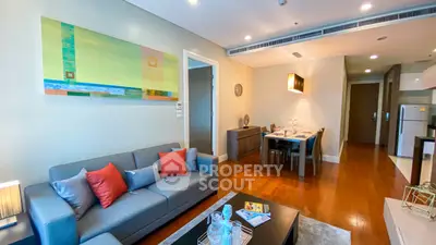 Modern living room with stylish decor and dining area in open layout apartment.