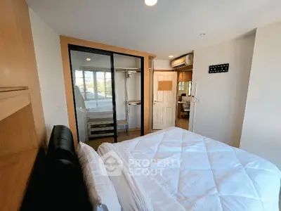 Cozy bedroom with modern closet and natural light