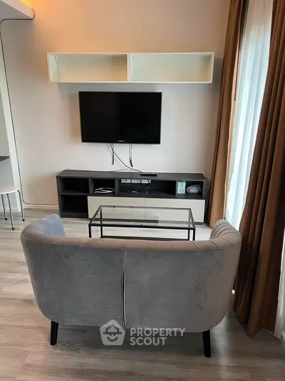 Modern living room with sleek furniture and wall-mounted TV, perfect for cozy relaxation.