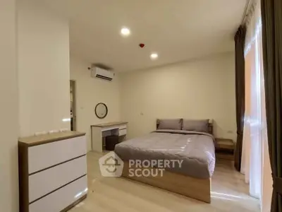 Spacious modern bedroom with elegant furnishings and natural light