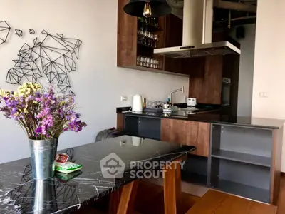 Modern kitchen with sleek black marble countertops and stylish wooden cabinets