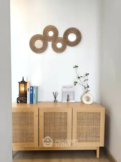 Stylish modern interior with wooden cabinet and decorative wall art in cozy living space.