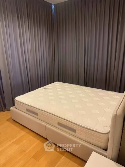 Spacious bedroom with elegant curtains and a comfortable bed, perfect for restful nights.