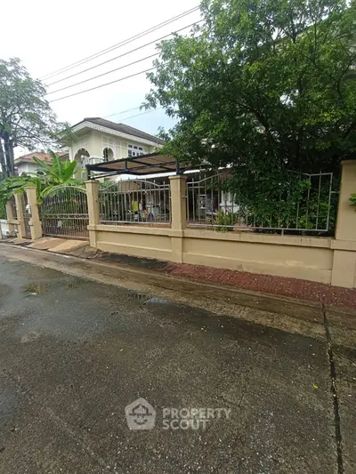 Charming suburban house with lush greenery and secure fencing