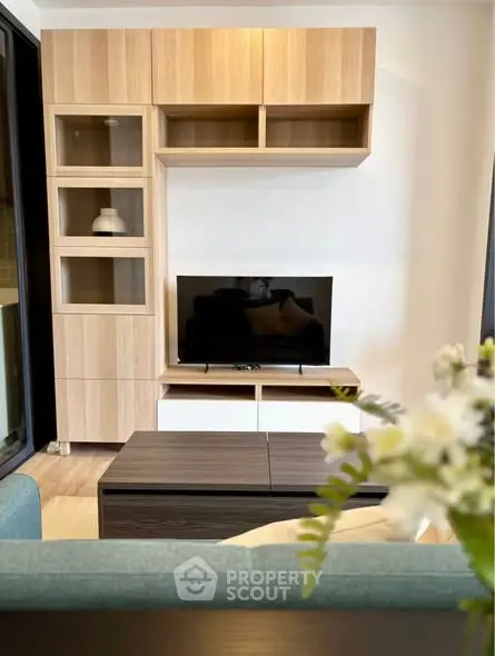 Modern living room with stylish wooden cabinetry and sleek TV setup