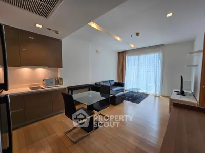 Modern open-plan living room with sleek kitchen and stylish furniture