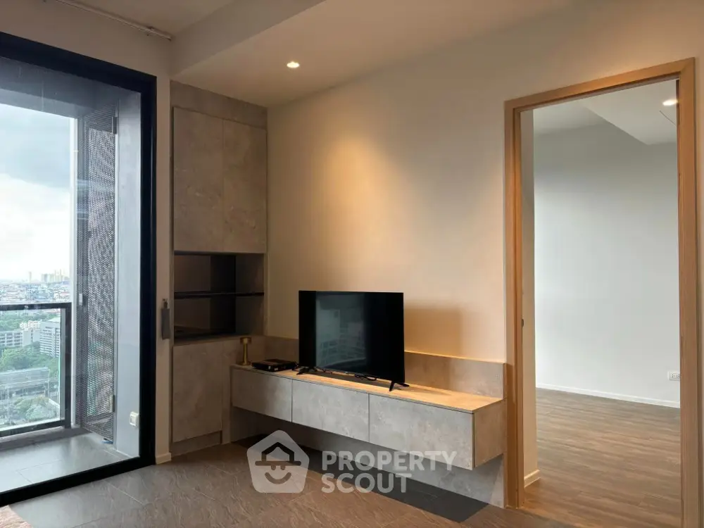 Modern living room with city view and sleek TV setup
