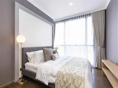 Elegant bedroom with large window and modern decor in luxury apartment