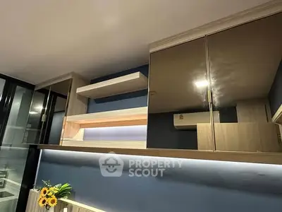 Modern kitchen with sleek cabinets and ambient lighting, perfect for contemporary living.
