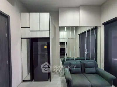 Modern living room with sleek furniture and mirrored wall design