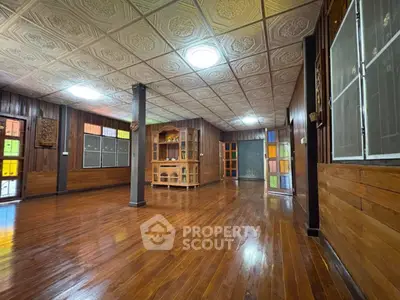 Spacious wooden interior with decorative ceiling and colorful glass accents.