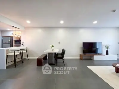 Spacious modern living room with open kitchen and sleek design