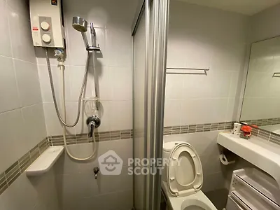 Compact bathroom with shower and toilet in modern apartment