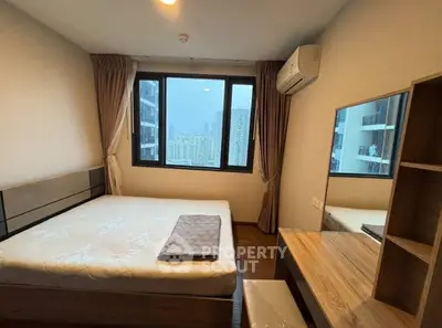 Modern bedroom with city view, featuring a comfortable bed, wooden furniture, and large windows.