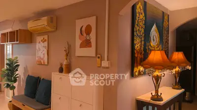 Charming living room with elegant decor and warm lighting, featuring stylish artwork and cozy seating.