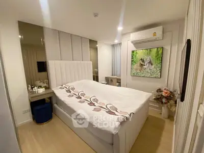Cozy bedroom with modern decor, featuring a plush bed, air conditioning, and stylish wall art.