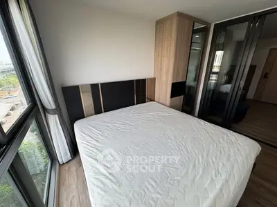 Modern bedroom with large windows and stylish wardrobe in a contemporary apartment.