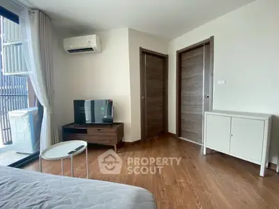 Modern bedroom with wooden flooring and stylish furniture