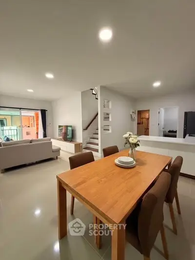 Spacious modern living room with open layout and elegant dining area, perfect for family gatherings.