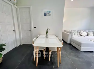 Modern living room with stylish dining area and cozy sofa, perfect for relaxation and entertaining.