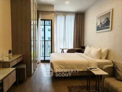 Luxurious bedroom with modern decor and balcony access in a high-end apartment.