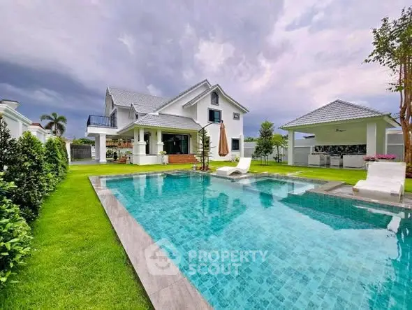 Luxurious villa with pristine pool and lush garden, perfect for serene living.