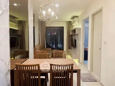 Modern living room with city view, elegant lighting, and stylish furniture in a high-rise apartment.