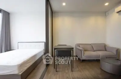Modern studio apartment with cozy living area and sleek design