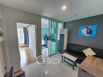 Modern living room with glass partition and stylish decor in a cozy apartment.